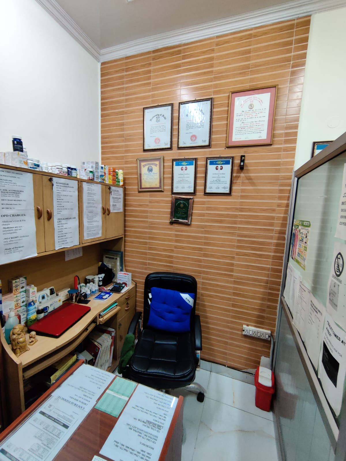 Reception area of Nitson Homeopathy clinic in Delhi with certificates on the wall