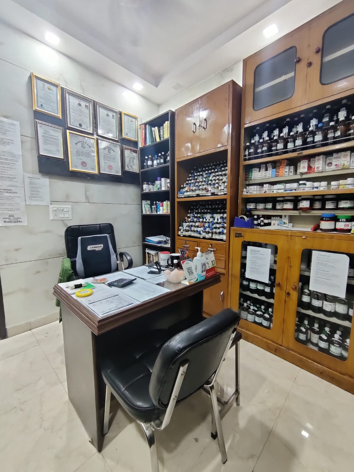 Nitson Homeopathy clinic consultation room with homeopathic medicine shelves